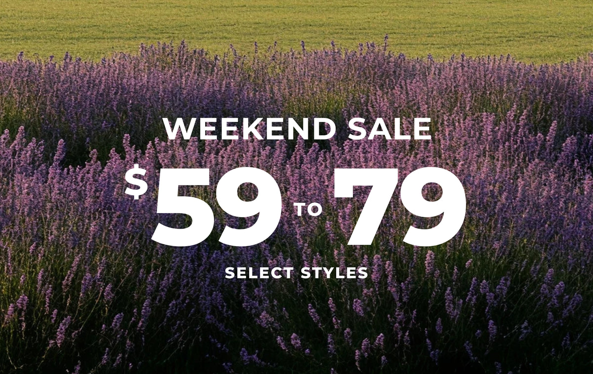 A promotional sale graphic over a field of purple lavender flowers, with large white text reading 'WEEKEND SALE $59 TO 79' and smaller text 'SELECT STYLES'.