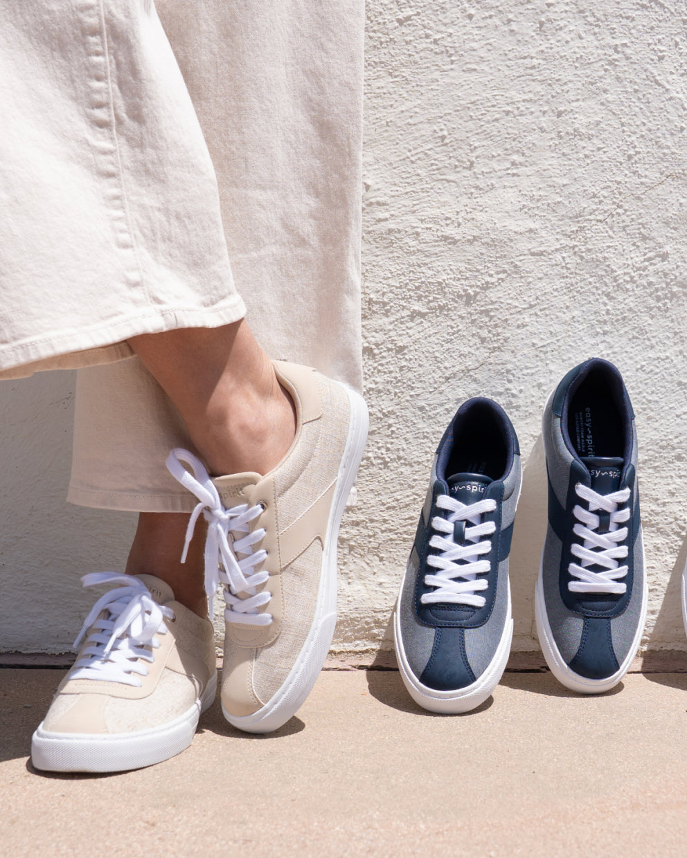 Model wearing Easy Spirit athleisure sneakers in white and navy