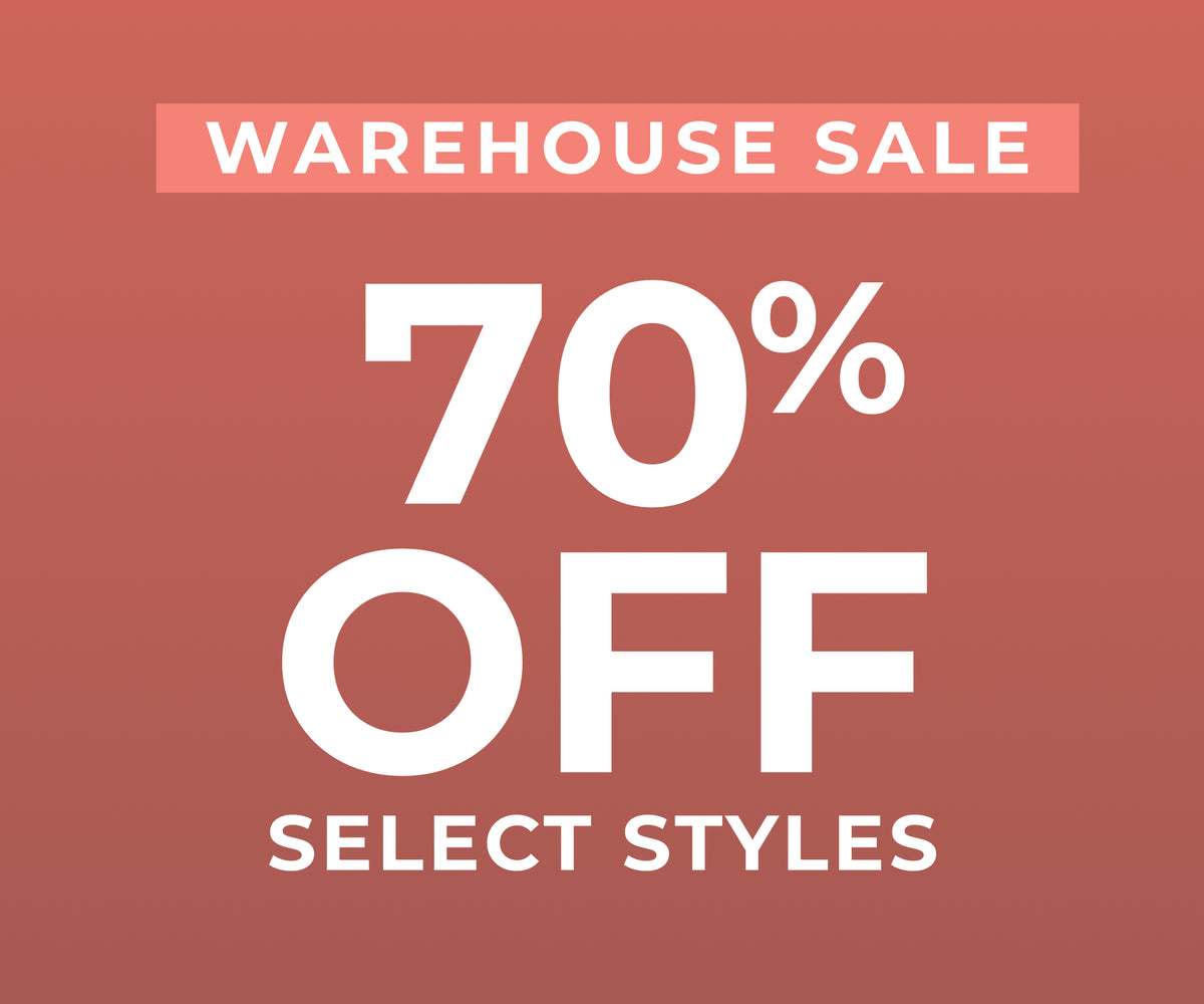 Promotional sale graphic with the text 'WAREHOUSE SALE 70% OFF SELECT STYLES' in white on a muted reddish-pink background.