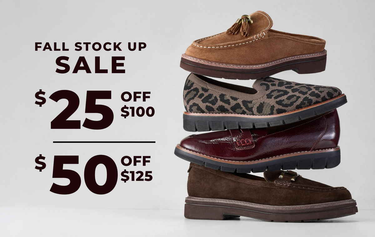 Four pairs of slip-on loafers stacked vertically on the right side against a light gray background, with large sale text on the left reading 'FALL STOCK UP SALE $25 OFF $100' and '$50 OFF $125'. The shoes include tan suede, leopard print, burgundy leather, and dark brown suede.