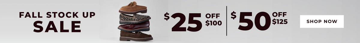 Promotional banner for a fall stock up sale, featuring a stack of brown leather boots and shoes in the center, with text offering $25 off $100 and $50 off $125, plus a white 'SHOP NOW' button on a light gray background.